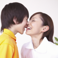 a boy kissing a women